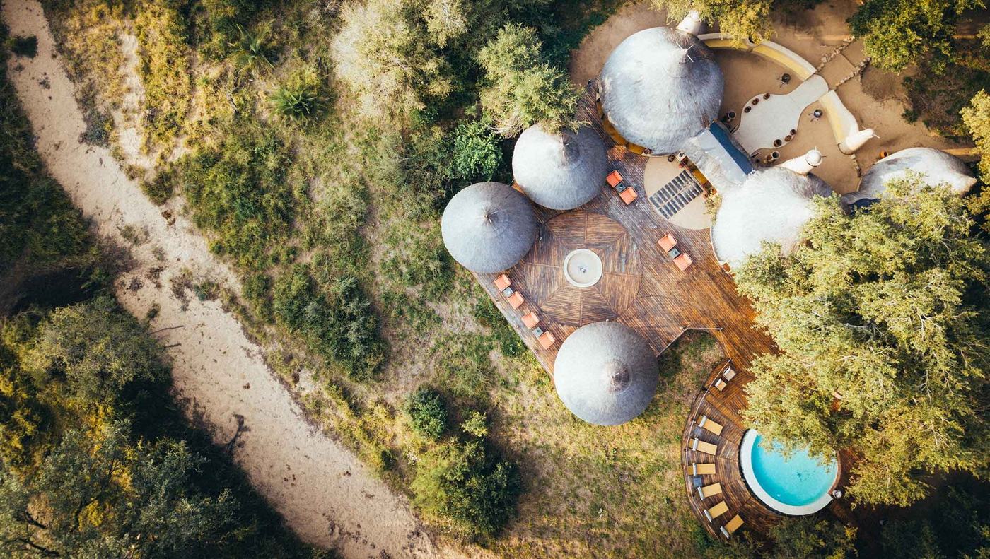 Aerial view of thatched suites and plunge pool at Hoyo Hoyo Safari Lodge