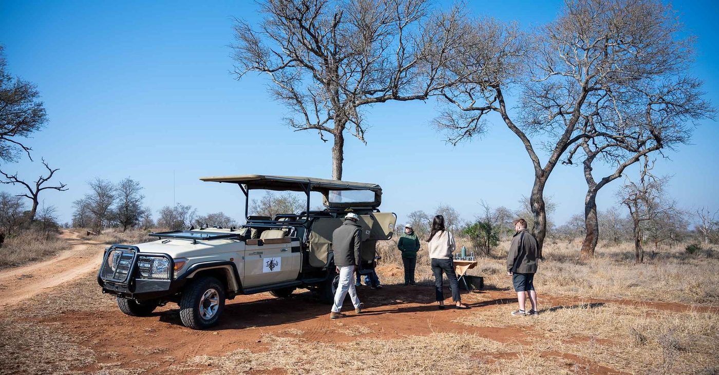Safari vehicle stopped with guests on a game drive near Imbali Safari Lodge