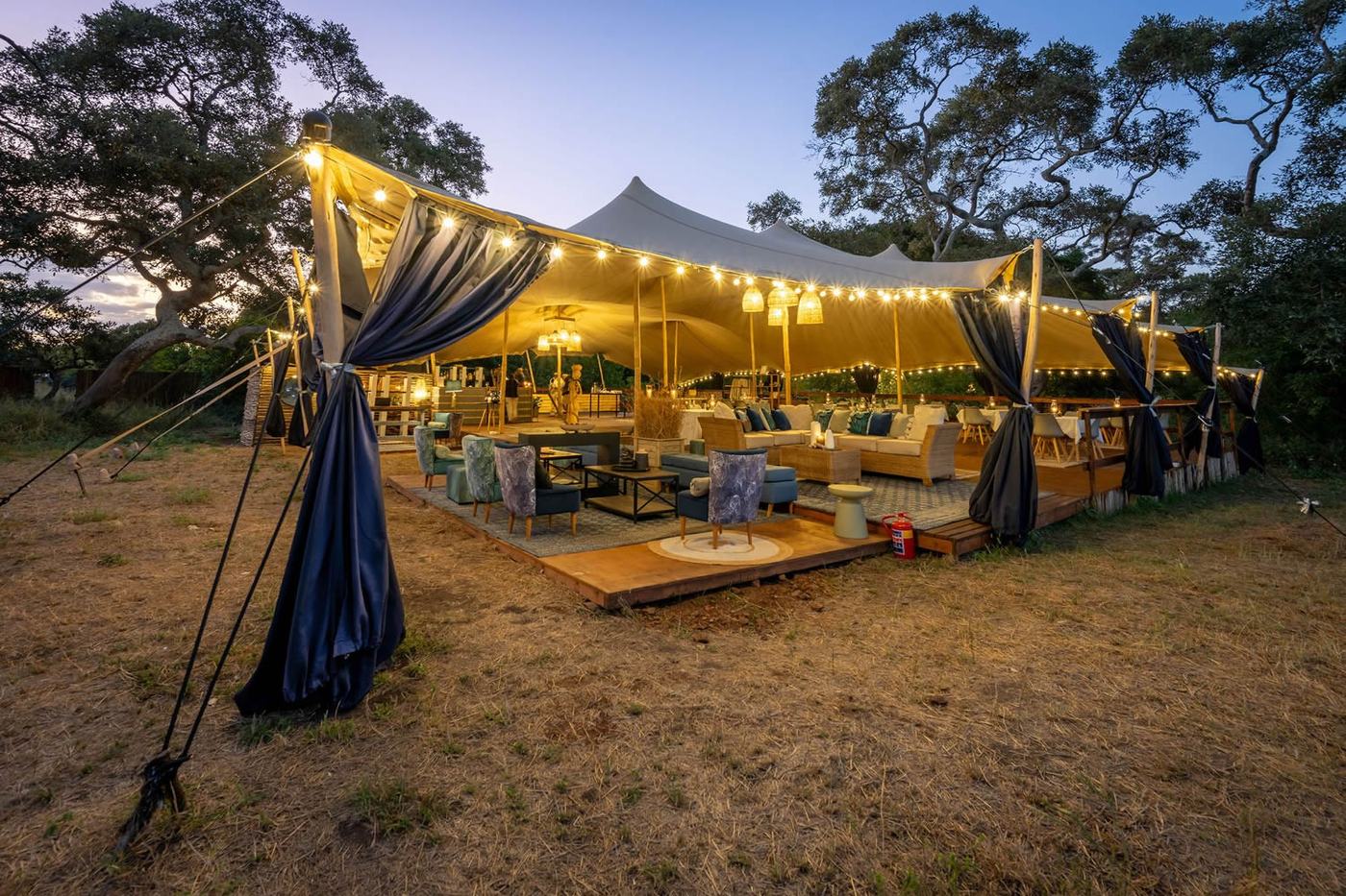 Kruger Untamed Satara Plains Camp lantern-lit mess tent at dusk in Kruger