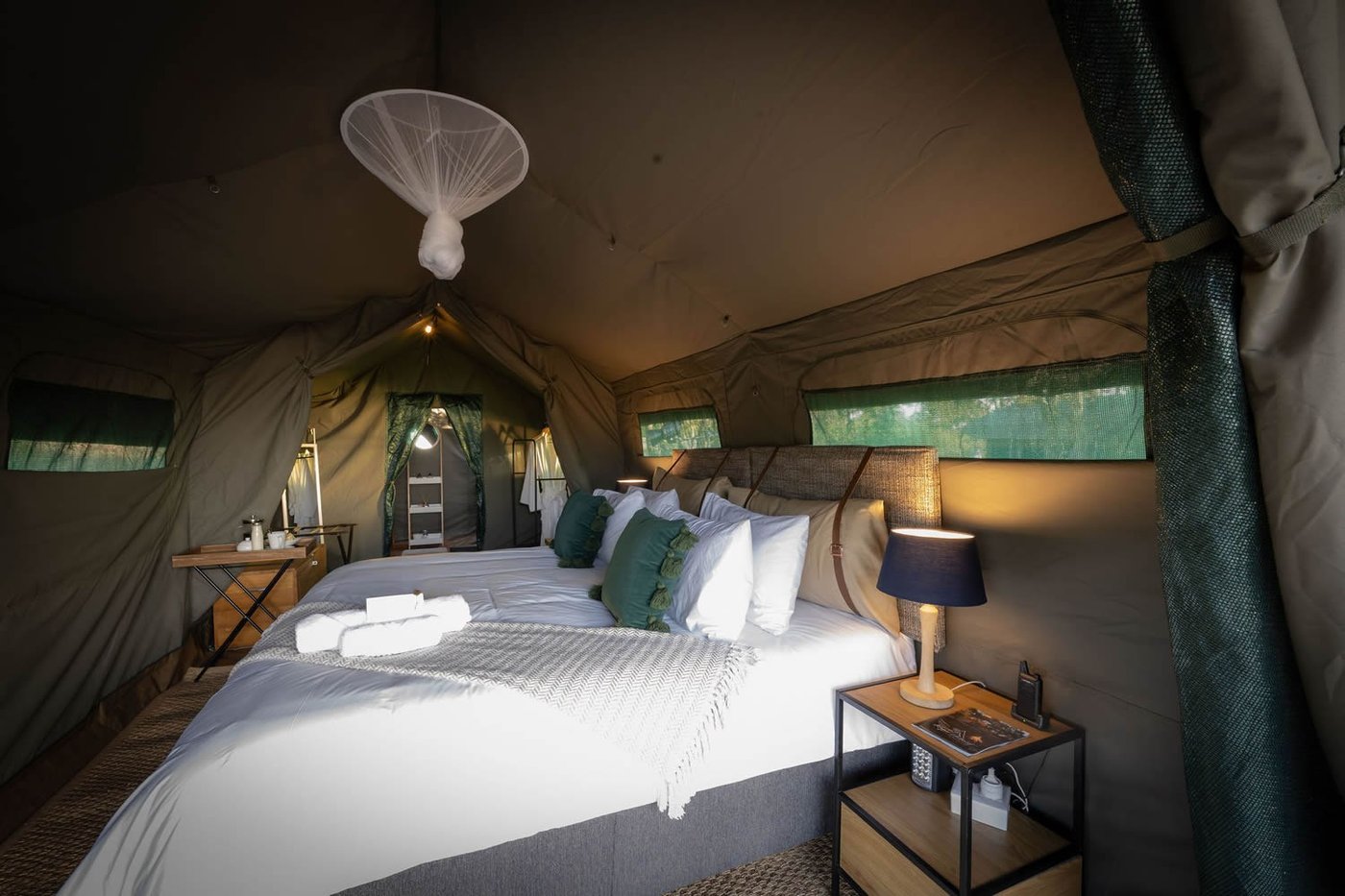 Canvas tent bedroom with a crisp white bed at Kruger Untamed Satara Plains Camp