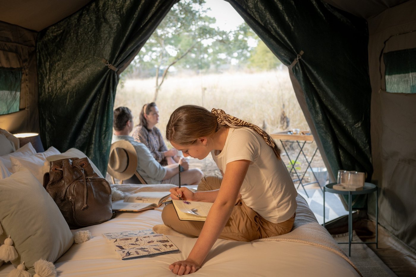 Canvas tent interior with twin beds and open sides at Tshokwane River Camp