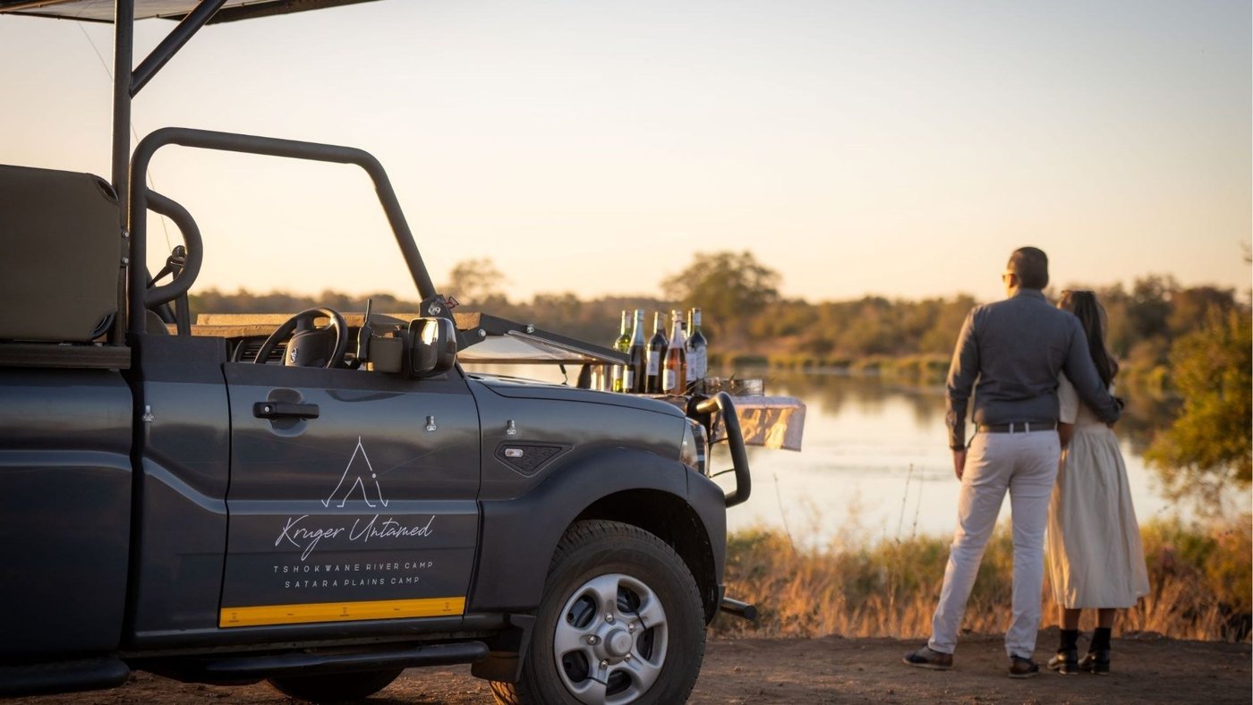 Open safari vehicle parked overlooking the river near Tshokwane River Camp