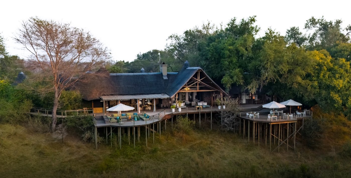Lion Sands Narina Lodge thatched suites perched above the riverbed in Kruger