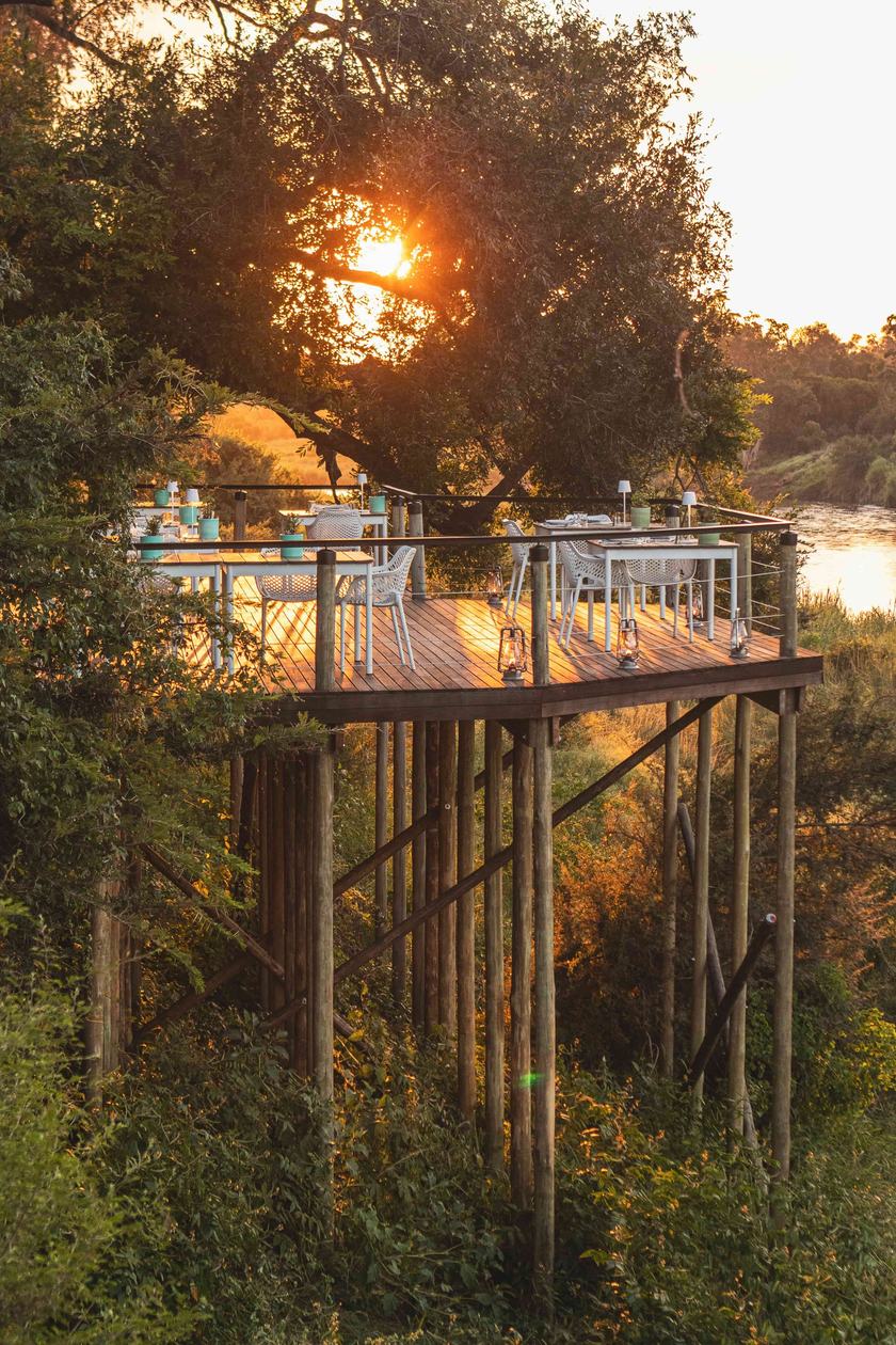 Elevated crow's nest deck in the treetops at sunset at Lion Sands Narina Lodge