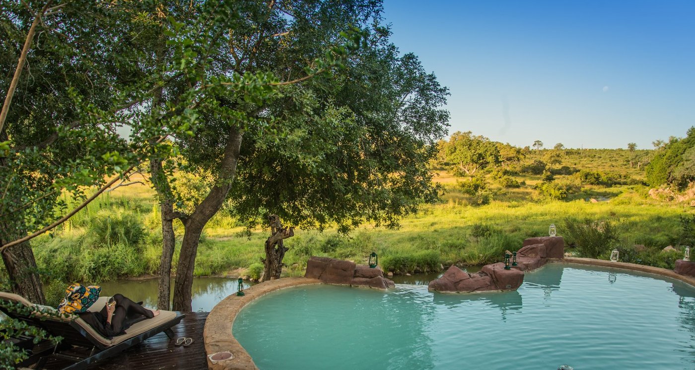 Pool deck surrounded by riverine bush at Lukimbi Safari Lodge