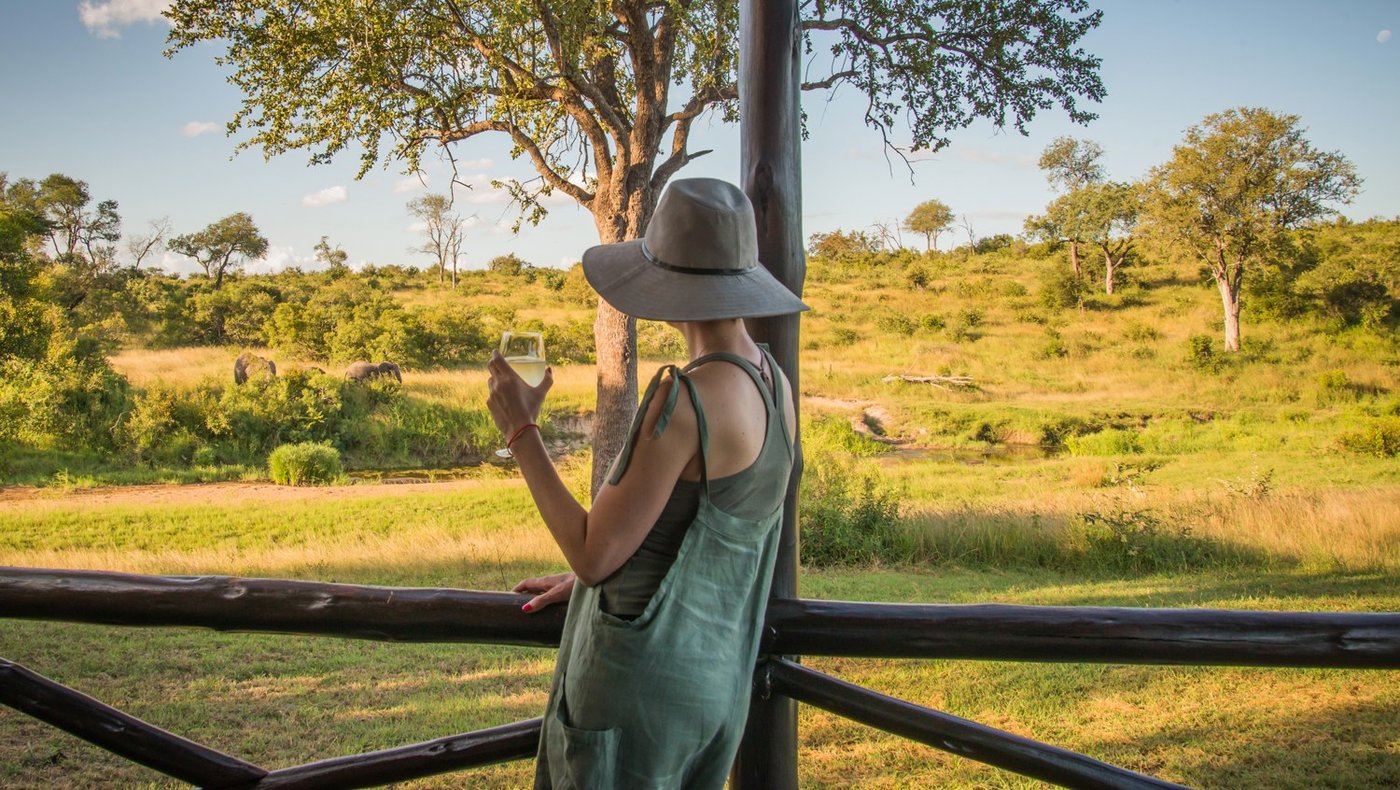 Guest watching the grassland from the viewing deck at Lukimbi Safari Lodge