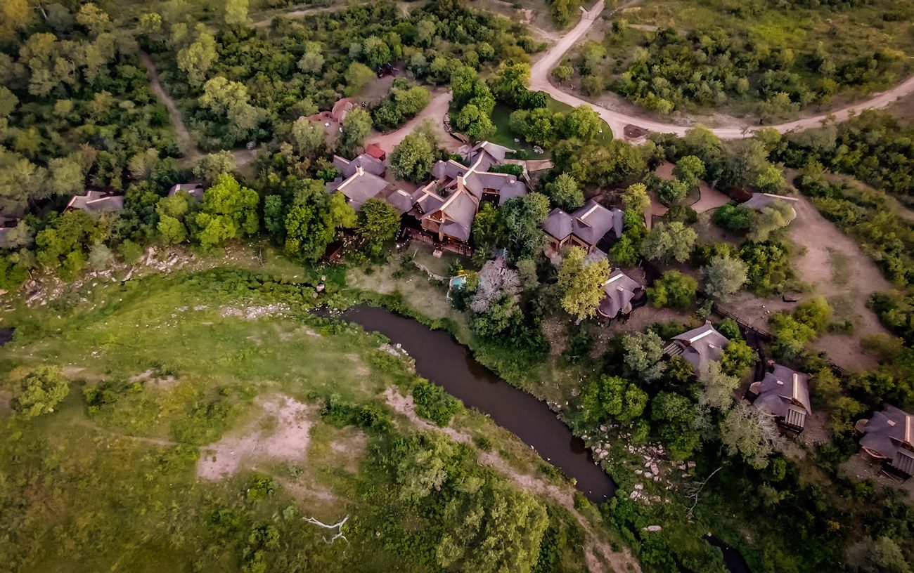 Aerial view of thatched suites linked by walkways at Lukimbi Safari Lodge