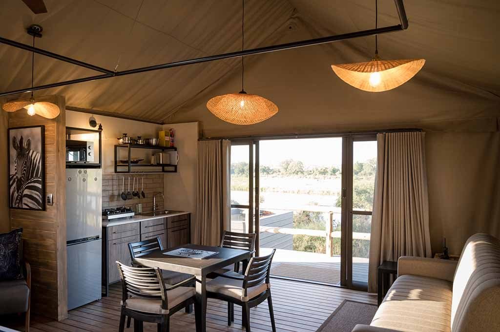 Lounge and dining nook overlooking the river at Nkuhlu Tented Camp