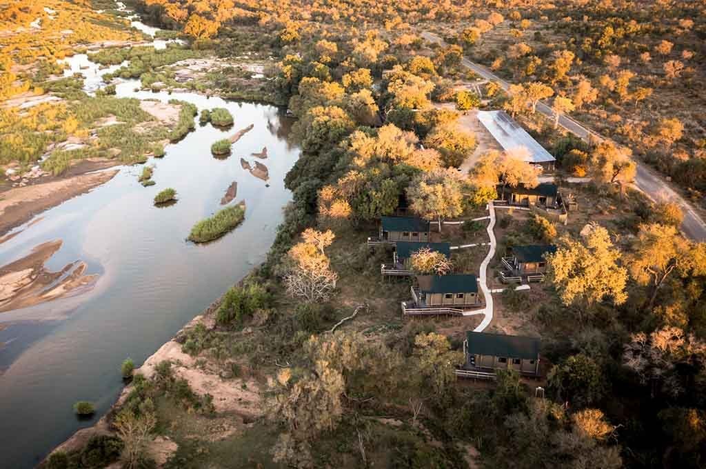 Aerial view of tented suites along the river bend at Nkuhlu Tented Camp
