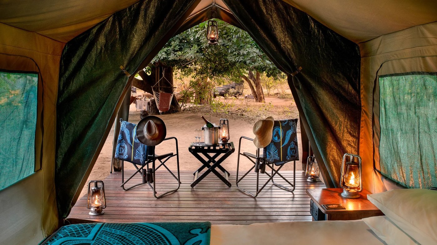 Tent interior framing camp chairs and lanterns at Nkula Walking Camp in Kruger