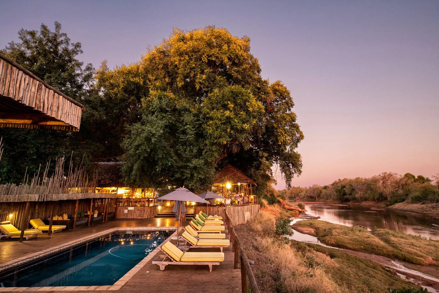 Pafuri Camp pool deck and thatched lounge beside the riverine forest in Kruger