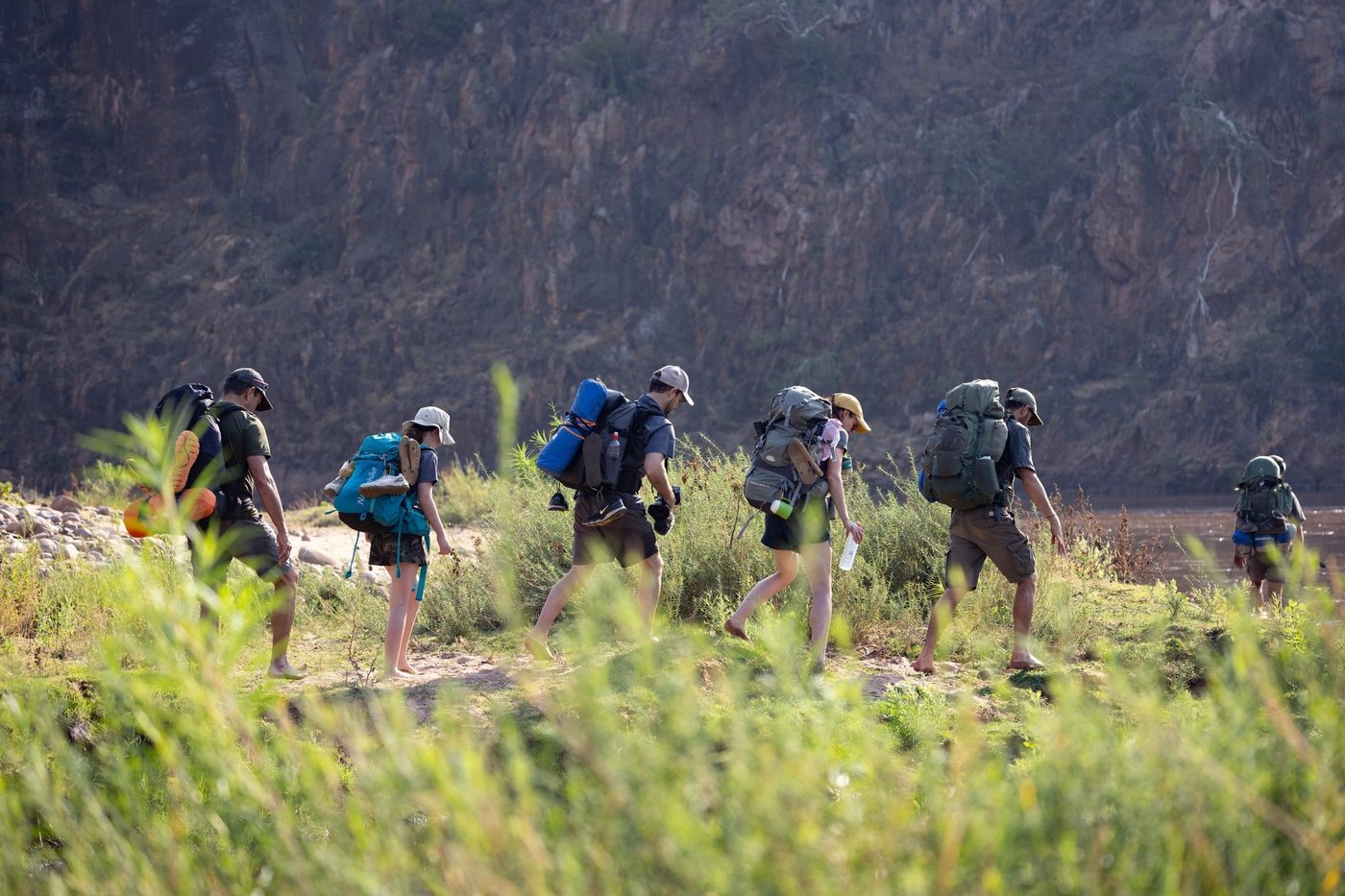 Line of hikers crossing open grassland on a guided walk near Pafuri Camp