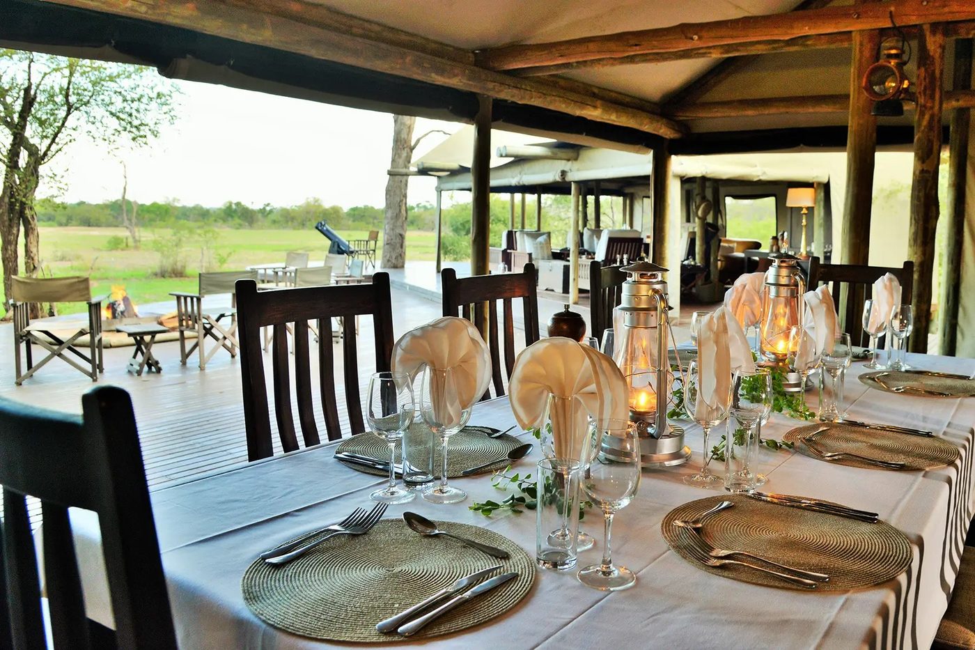 Lantern-lit dining deck overlooking the bush at Plains Camp