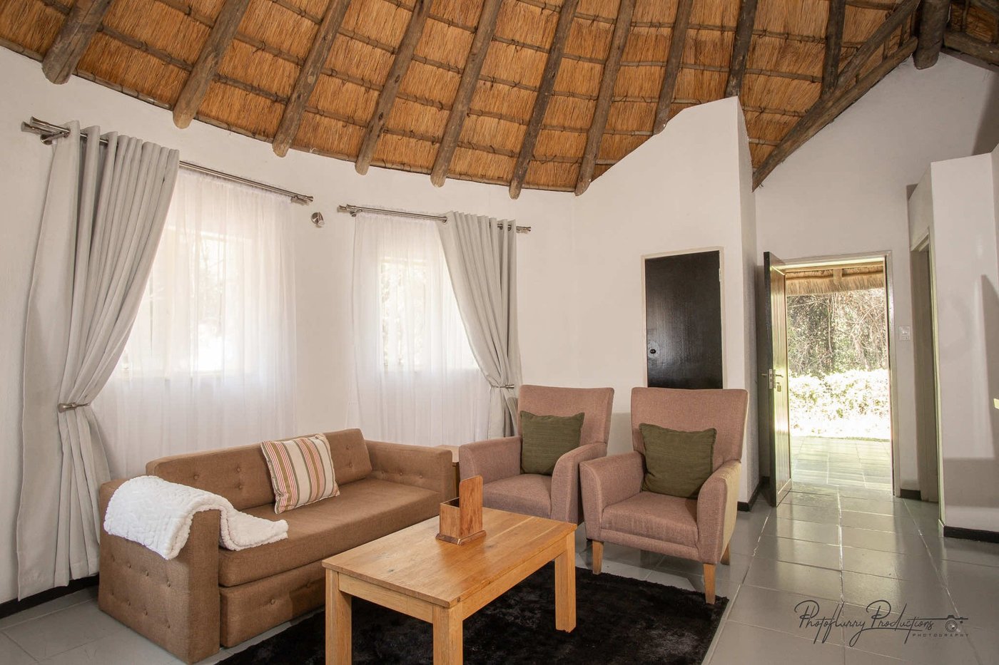 Lounge with sofas and garden views at Sefapane Lodge