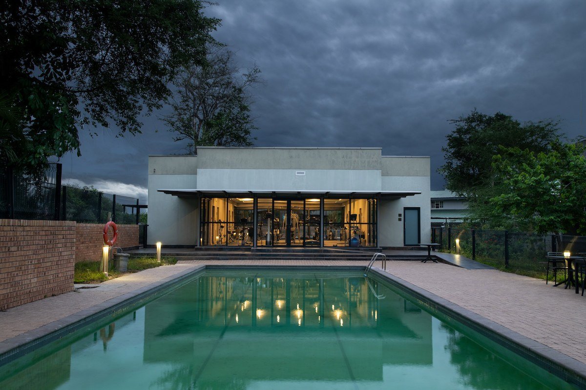 Skukuza Safari Lodge modern wing and pool lit at dusk in Kruger