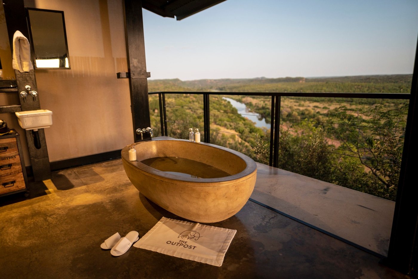 The Outpost freestanding bathtub facing an open view of the valley in Kruger